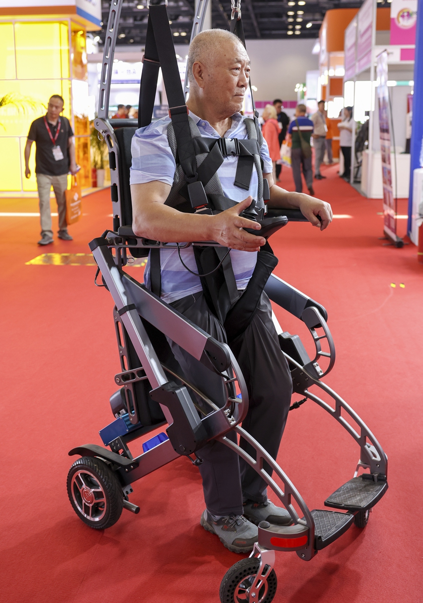 A visitor tries out a smart walking robot at the China International Senior Services Expo in Beijing on May 21, 2024. Photo: IC
