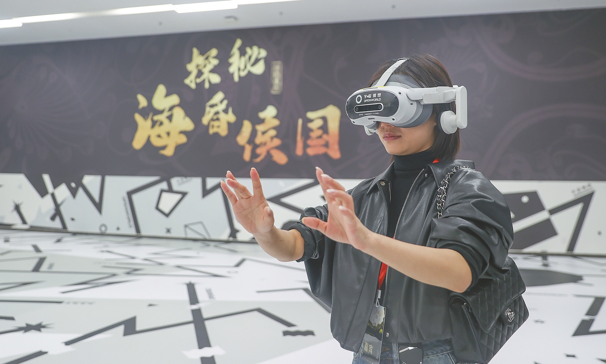 A visitor explores a digital immersive exhibition on the Haihun Kingdom using a VR headset at the Nanchang Relic Museum for the Haihun Principality of the Han Dynasty in East China's Jiangxi Province on April 2. The exhibition uses immersive storytelling and advanced technologies, including VR, AR, and spatial positioning, for visitors to interact with ancient Haihun Kingdom like never before. Photo: VCG