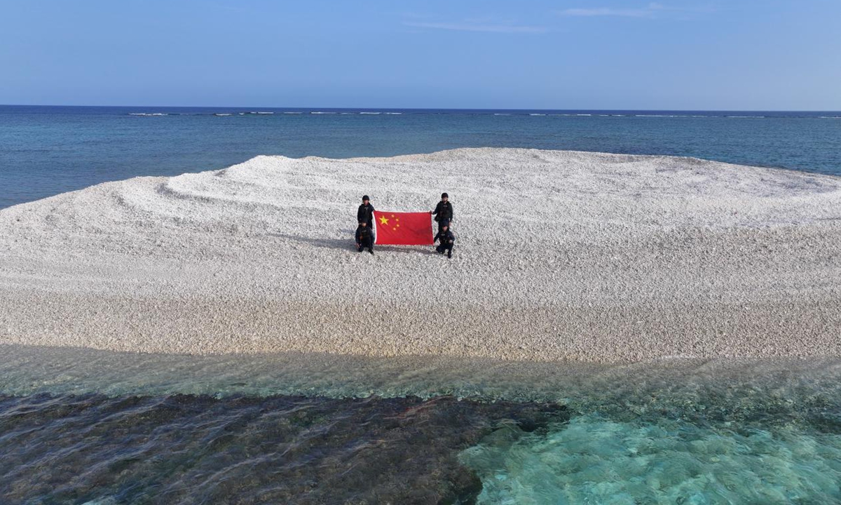 Photo: China Coast Guard displays the Chinese national flag at Tiexian Jiao in the South China Sea.