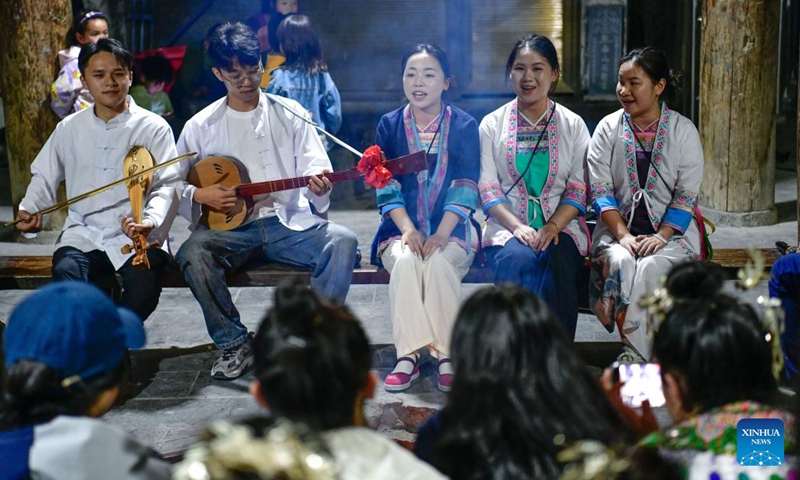 Chorus members teach children to sing songs of the Dong ethnic group in Zhaoxing Town of Liping County, southwest China's Guizhou Province, April 22, 2025.（Photo: Xinhua)