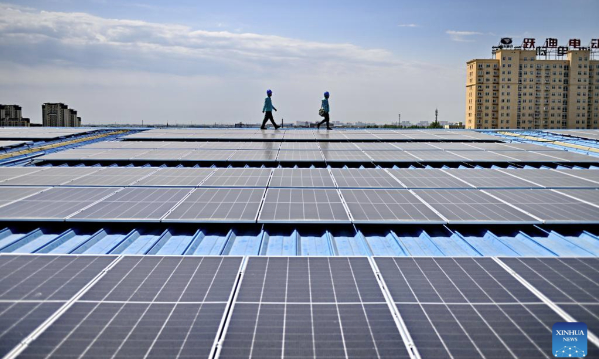 Staff members of the State Grid in Yuanshi County patrol the rooftop photovoltaic devices at a technology company in Yuanshi County, north China's Hebei Province, May 14, 2025. In recent years, Yuanshi County has encouraged local companies to set up photovoltaic power generation devices on their roofs, aiming to promote the development of green economy and to reduce their management cost. These rooftop devices now boast a combined power generating capacity of 29.49 megawatt connected to the power grid. (Xinhua/Mu Yu)